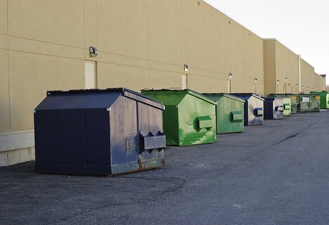 a construction worker moves construction materials near a dumpster in Aliso Viejo